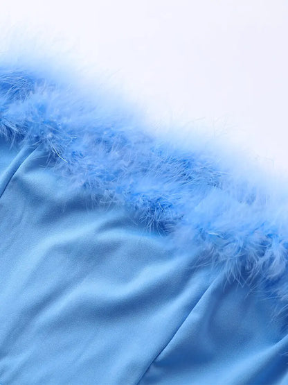 Dames jumpsuit met pailletten en verenpanelen
